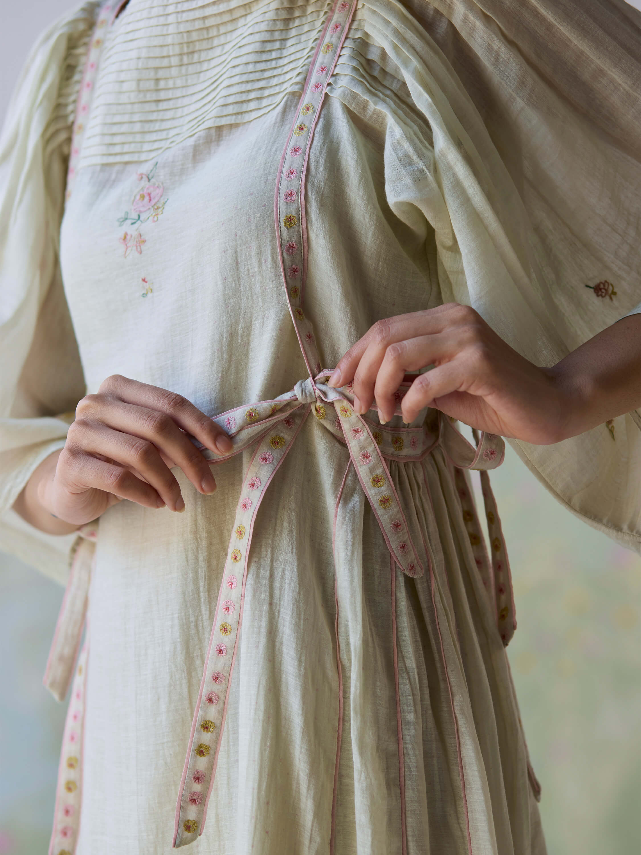 Close-up of Amore Midi Dress with intricate embroidery and ribbon ties.