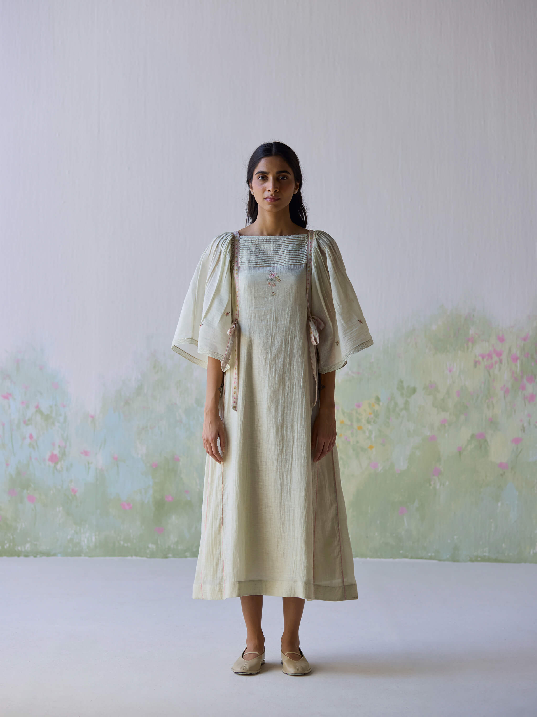 Model showcasing the Amore Midi Dress in a serene setting.