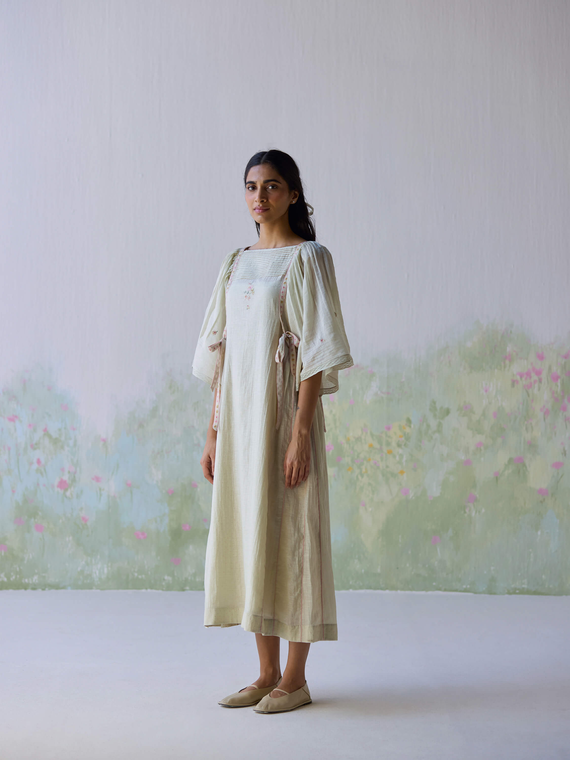 Elegant model in Amore Midi Dress, featuring soft pastel colors.