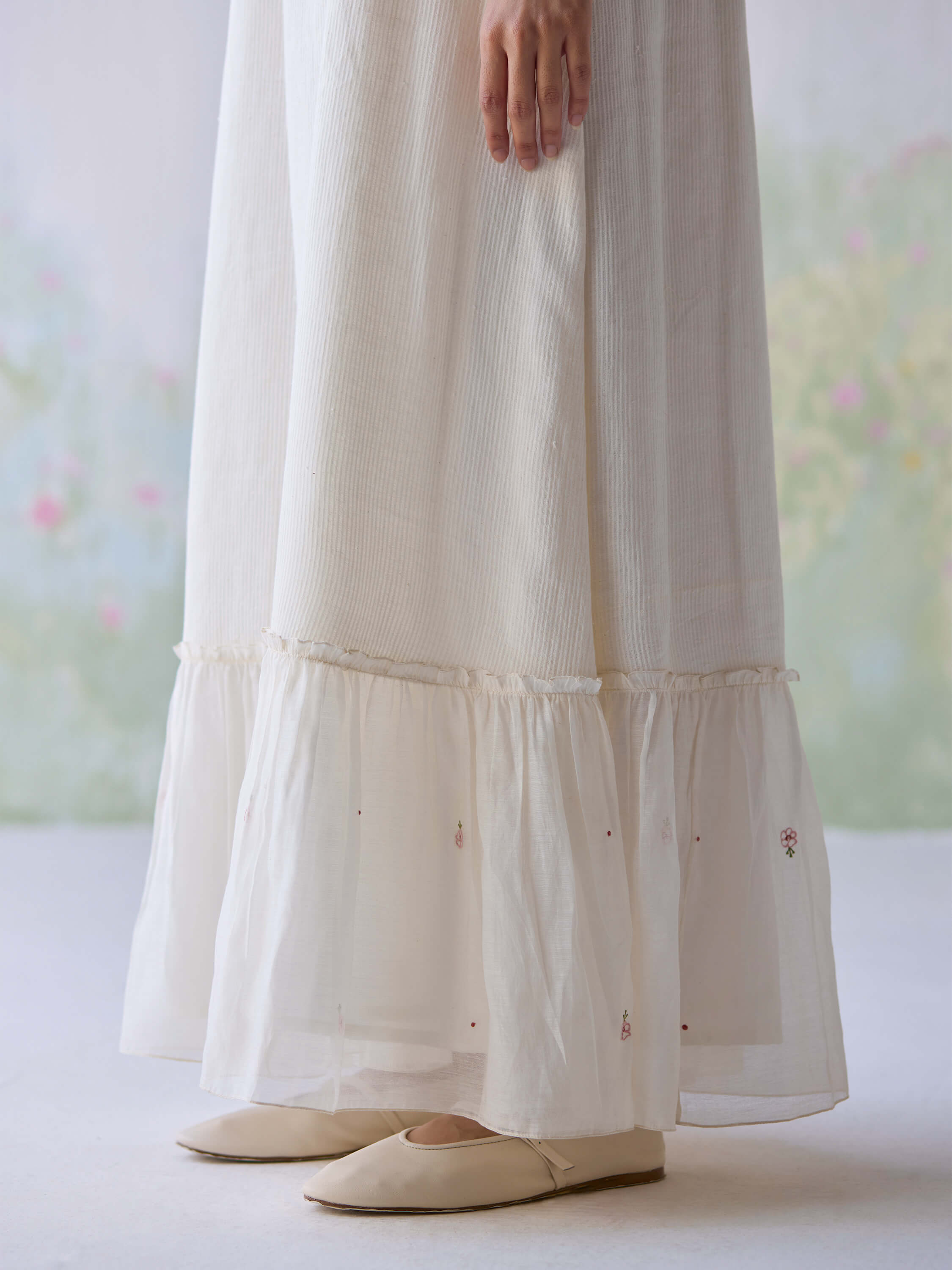 Elegant Belle Maxi Dress with tiered hem and delicate floral embroidery.