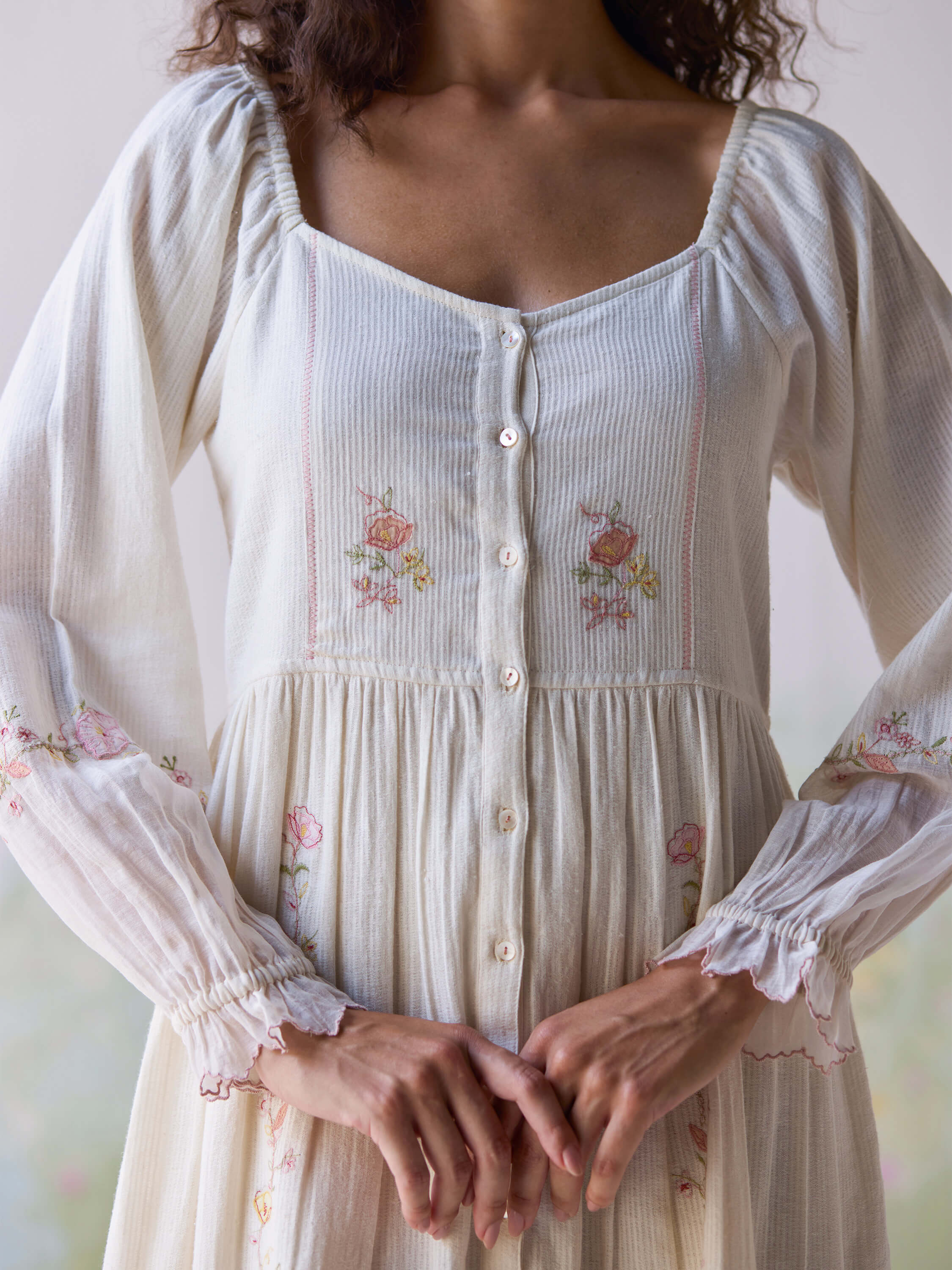 Elegant Verona Midi Dress with floral embroidery and button details.