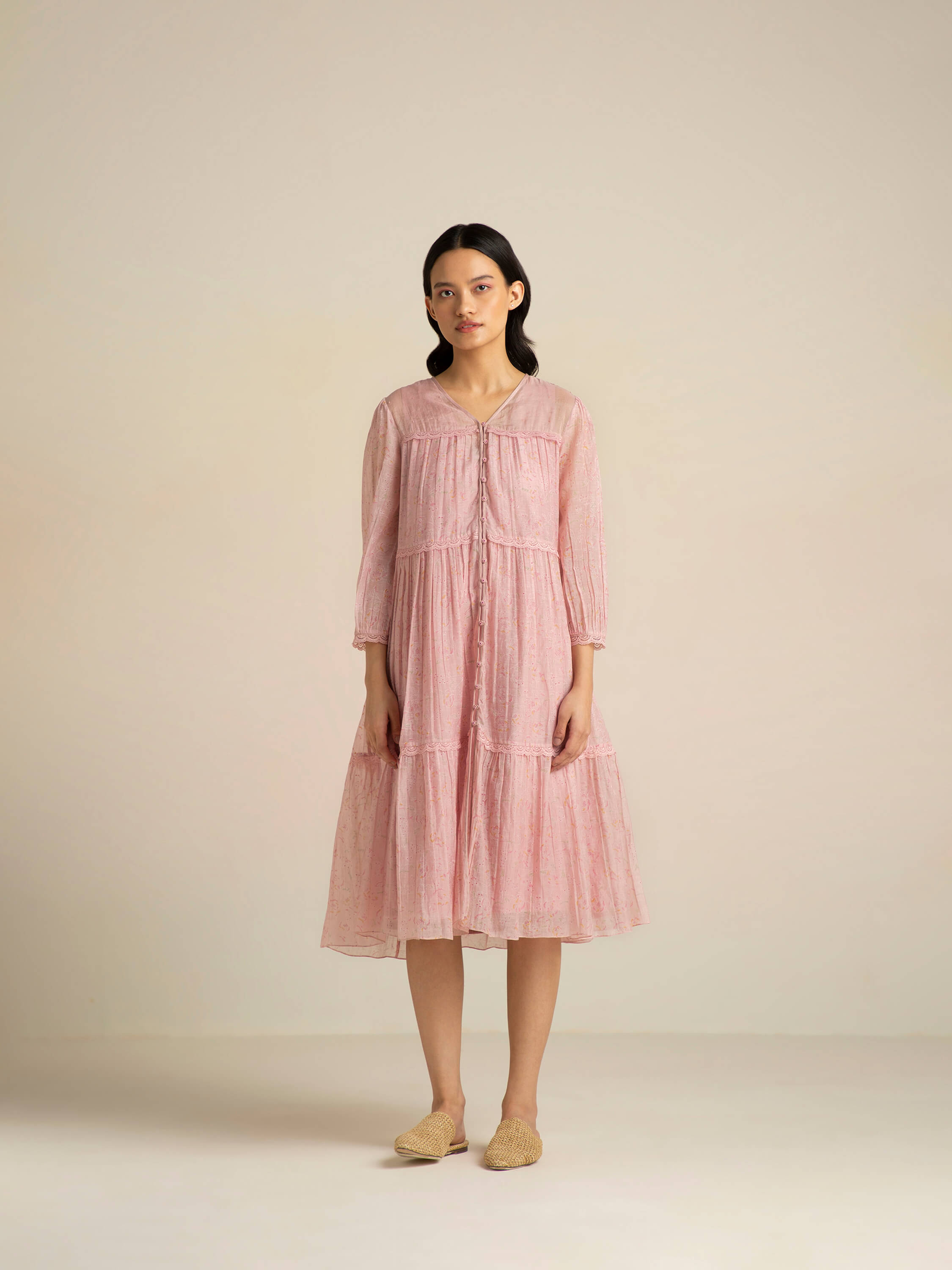 Woman modeling long pink dress with woven slip-on shoes