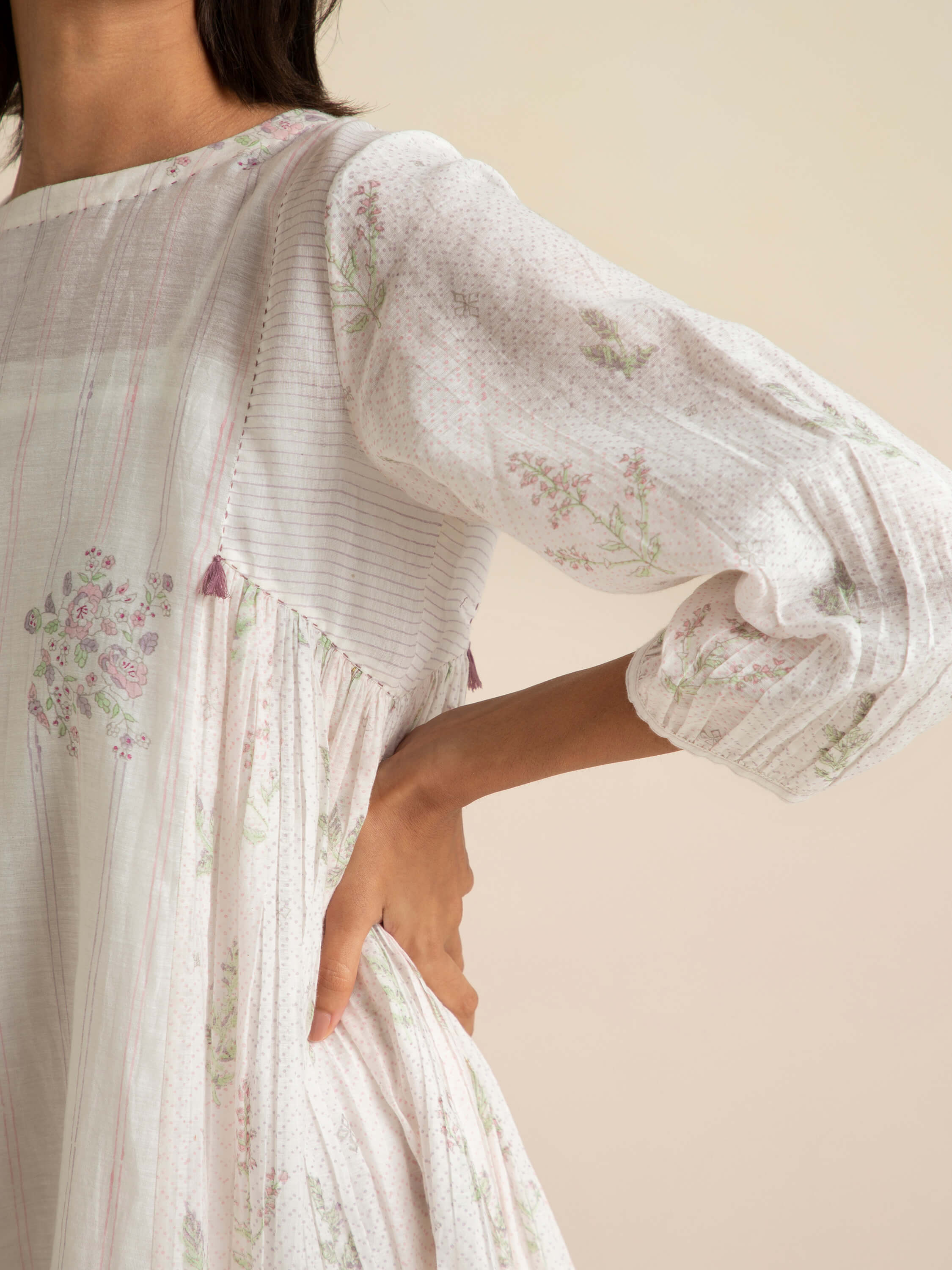 Close-up of a woman wearing a floral-patterned light dress.